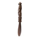 A Massim lime spatula Trobriand Islands, Papua New Guinea with a carved and pierced seated figure,