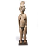 A Wosera standing female figure Papua New Guinea with a sloping back headdress and shallow crested