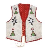 A Western Sioux fully beaded vest Plains buckskin with lazy stitch of a white ground with