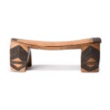 A Zulu headrest South Africa with carved linear and burnished decoration, 12.5cm high, 34cm long.