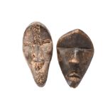 Two Dan passport masks Ivory Coast one with carved chevron bands, 7.7cm and 7cm high. (2)