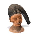 A Yoruba egungun headdress Nigeria with a black painted coiffure, 35.5cm high.