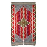 A Navajo Germantown rug Southwest North America with a central medallion and serrated bands, 187cm x