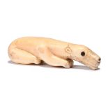 λAn Inuit polar bear amulet Alaska walrus ivory with baleen, with an attachment hole through the