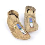 A pair of Arapaho moccasins Plains hide with blue, red, white, green, black, teal and clear green