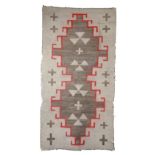 A Navajo rug Southwest North America with geometric designs including crosses, 162cm x 85cm.