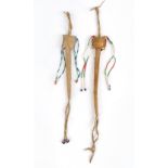 Two Plains awl cases hide with coloured glass beads, 31cm and 35cm long. (2) Provenance Edith
