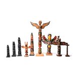 Nine model totem poles five carved cedar or pine with polychrome decoration and four resin, 20th