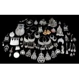 A collection of Nubian jewellery including silver coloured metal pendants; two Egyptian temple
