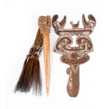 An Asmat cassowary bone dagger Irian Jaya, Indonesia with fibre, beads and feathers, 37cm long,