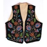 An Ojibwa vest Northeast North America cloth and coloured glass beads, the black cloth fronts with