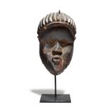 A Bassa mask Liberia 21cm high, on a stand. (2) Provenance UK collection. Owen Hargreaves, London.