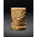 A Marquesas Islands ornament ivi po'o Polynesia bone, carved as a tiki with the remains of a red