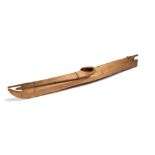 An Inuit model kayak Norton Sound, Alaska wood frame with sealskin and a painted oar, with a