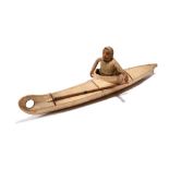 λAn Inuit model kayak Nunivak Island, Alaska wood frame with sealskin and a half figure hunter