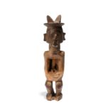 A Teke power figure Democratic Republic of the Congo with a twin crested coiffure and a short beard,