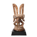 An Igbo Ikenga shrine figure Nigeria with remains of pigment, 23cm high, on a wood base. (2)