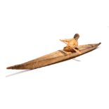 An Inuit model kayak Labrador, Canada wood frame with sealskin and with a hunter figure wearing a