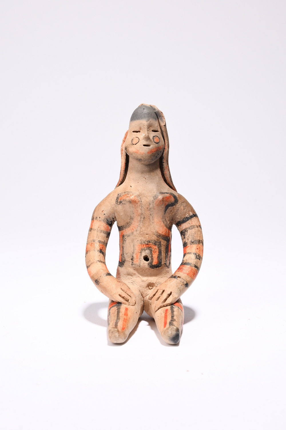 An Amazonian seated female figure Brazil earthenware with red and black decoration, 12cm high. - Image 3 of 3