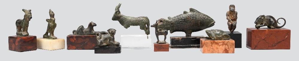 A collection of bronze animal amulets and models Egyptian, Roman and later including an Apis Bull,