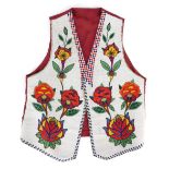 A Plains vest possibly Crow or Flathead thick cloth, printed cotton, satin and coloured glass