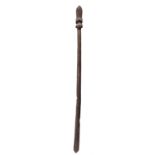 A Maori child's taiaha staff New Zealand carved with head and tongue profile and a pointed terminal,