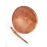 A Blackfoot hand drum Plains bentwood with a rawhide skin and with the remains of red pigment, circa