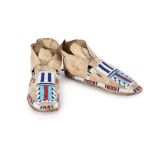 A pair of Cheyenne moccasins Plains buckskin, rawhide and coloured glass beads with geometric