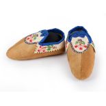 A pair of Athapaskan child's moccasins Subarctic smoked moose hide, caribou, coloured thread, dyed