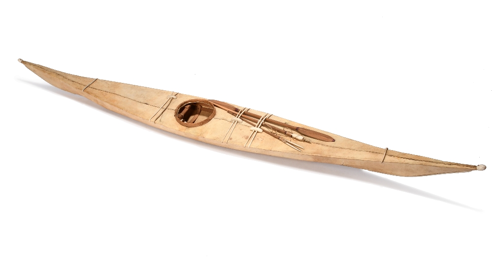 λAn Inuit model kayak Greenland wood frame with sealskin and marine ivory mounts, with an oar and