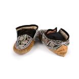 A pair of Maliseet moccasins Northeast North America moose hide, cloth, velvet and coloured glass