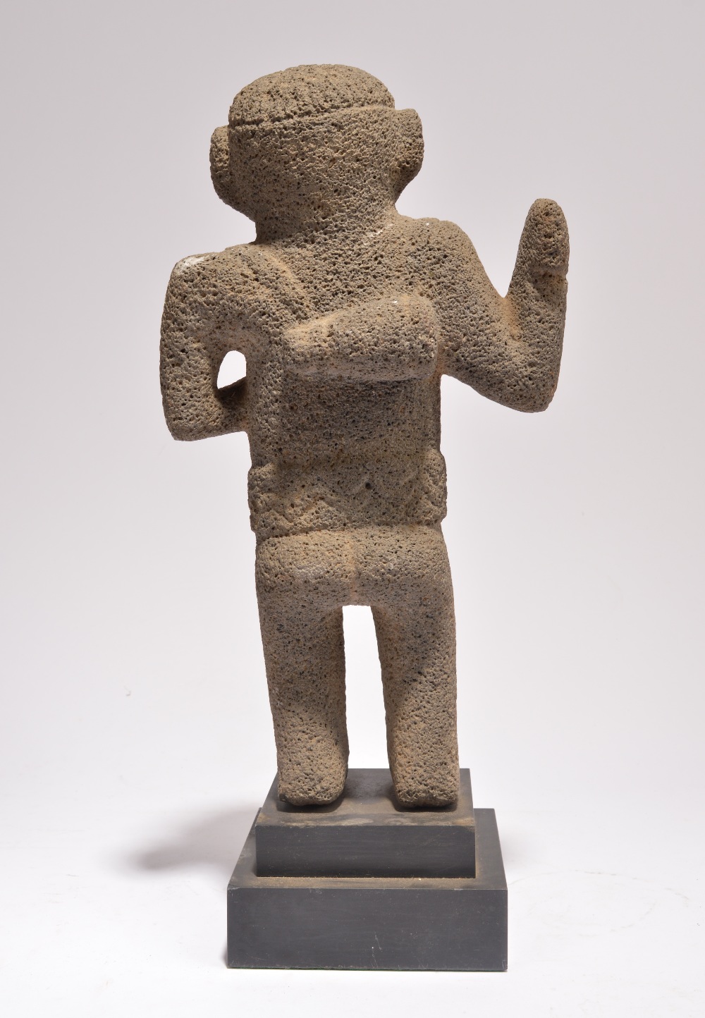 A Costa Rica standing figure volcanic rock, with a crossed and ribbed coiffure, holding an axe in - Image 2 of 3