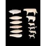 λA collection of twelve Inuit carved animals Alaska marine ivory, including a walrus, a narwhal,