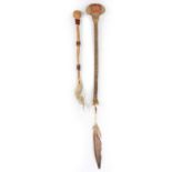 A Sioux stone head club Plains ovoid with a wood handle, hide bound and with four dyed quill