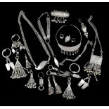 A Bedouin hirz receptacle silver coloured metal with chain, chased decoration and hung with bells,