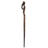 A Timor staff Indonesia with an open handle having a carved head wearing a pointed headdress, with