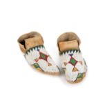 A pair of Ute moccasins Great Basin buckskin, rawhide and coloured glass beads in lazy stitch with