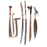 A collection of South East Asian weapons, comprising: a Moro sword (barong), heavy leaf-shaped