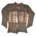 An Indian shirt of mail and lamellar armour, constructed of alternating rows of welded and riveted