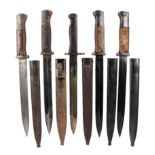 Four German K98 bayonets, blades 9 3/4 in. steel hilts with wooden grips and flask guards, steel