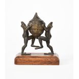 A novelty patinated bronze frog inkwell, modelled as two frogs standing on hind legs, holding up the