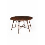 A Brazilian pine table in the manner of Morris & Co, circular top on six flaring, turned legs,