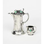 An Art Nouveau Hutton Secessionist pewter coffee pot and milk jug, model no.0599, the coffee pot