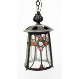 A patinated metal and glass hall lantern, flaring conical form, the leaded glass shade with stylised