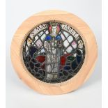A stained glass St Margaret roundel panel, depicted holding a sword and Corpus Christi, before a