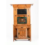 A Liberty & Co oak hallstand, rectangular with flaring over-mantel top, the back inlaid with