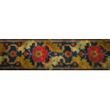 A long carpet runner, in the manner of Alexander Morton, decorated with a red flower repeat, on