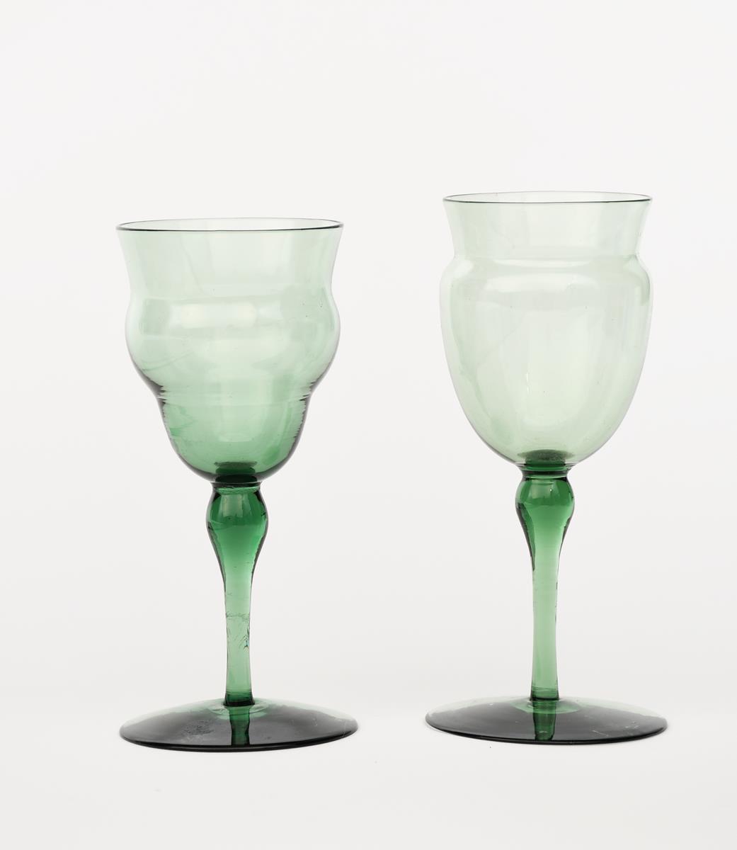 Two James Powell & Sons Whitefriars emerald green wine glasses designed by T G Jackson, each with