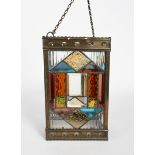 A patinated brass and stained glass hall lantern, square section, the frame pierced with crescent