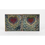 A pair of Pilkington's Lancastrian tiles, each painted with a simple heart motif on scale ground, in